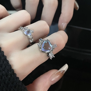 Y2K style heart-shaped moonstone ring with liquid metal texture and zircon accents