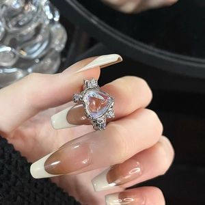 Elegant heart-shaped moonstone ring with sparkling crown details on hand