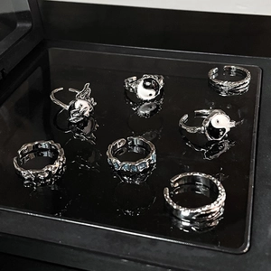 7-piece silver Tai Chi rings set with lava texture and heart design on black mirror surface