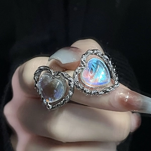 Moonstone heart earrings with silver braided texture frame and iridescent gemstone glow