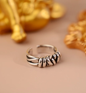 Detail view of vintage woven silver ring with multi-layer braided texture and adjustable band