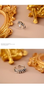Close-up of vintage silver braided twist ring showing intricate woven texture and detail
