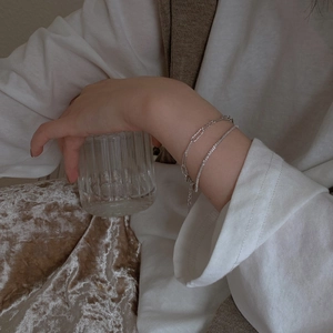 Sparkling silver layered bracelet set featuring paperclip chain and shimmering zirconia