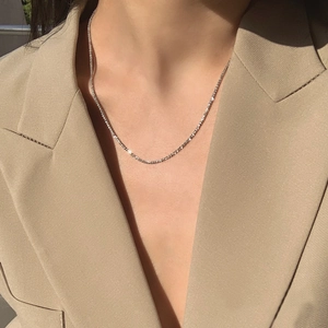 Sparkling silver stardust necklace worn with a khaki blazer for a minimalist chic look