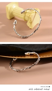 Detailed macro view of the vintage floral vine texture and S925 stamp on the silver bangle