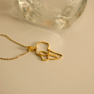 Minimalist gold stainless steel necklace featuring an artistic Africa map cross pendant