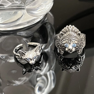 Vintage silver cat rings with blue gemstone eyes and Indian chief feather crown design