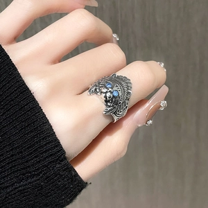 Vintage oxidized silver cat owl ring with blue crystal eyes worn on index finger