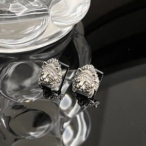 Retro cat ear studs with Indian feather headdress design on reflective background