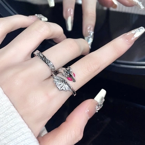 Retro dragon wings ring set in vintage silver with red eye detail and textured band