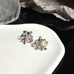 Artistic silver fluid rabbit earrings with iridescent moonstone beads on display