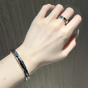 Dark industrial style silver bracelet and ring set with black lava texture design