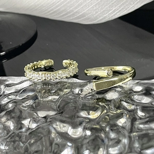 Minimalist gold adjustable rings set featuring zircon stones on a sleek reflective surface