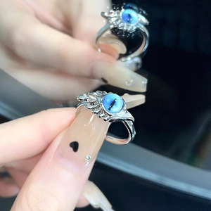 Adjustable evil eye ring featuring a deep blue cat eye stone in a silver vintage setting