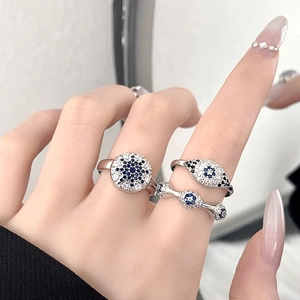 Turkish Evil Eye ring set in silver with blue and white zircons on model hand