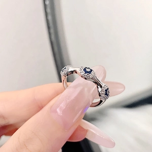 Elegant silver Evil Eye ring with blue zircons and irregular streamline band design