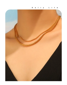 Close-up of double-layered gold wheat chain necklace with PVD plating on a model