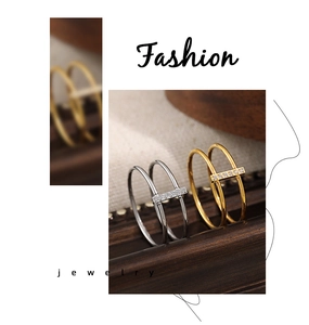 Detail view of double-banded rings with pave-set zircons in gold and silver tones