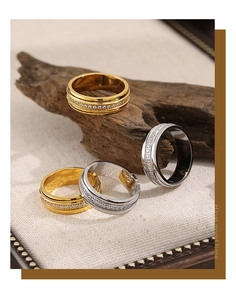 Detail of gold and silver eternity rings with cubic zirconia on woven fabric