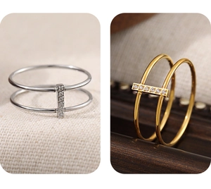Detail of double-layered rings in gold and silver finish with crystal pavé bar