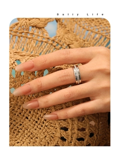 Silver-tone channel-set eternity ring with round cubic zirconia on a summer beach hat