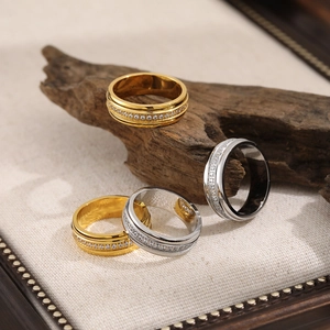 Rotating stainless steel spinner ring with sparkling cubic zirconia in gold and silver