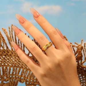 Fashionable 18K gold plated stainless steel ring with micro-pave crystals worn outdoors