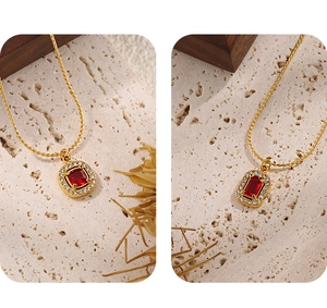 Close-up of gold-plated titanium steel necklace with a red zircon heart pendant