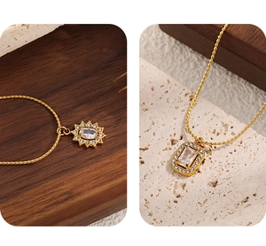 Detail of 18K gold plated titanium steel necklaces with sparkling zircon pendants