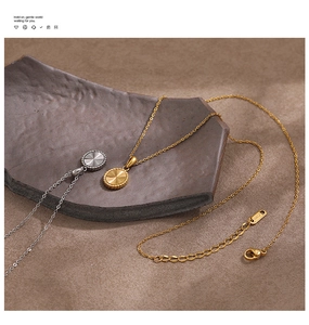 Detail of gold and silver sunburst pendant necklaces with 18KGP lobster clasp closure