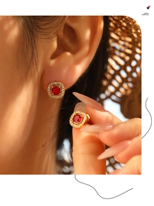 Detailed close-up of vintage square ruby earrings with micro-set diamonds in gold finish