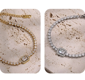 Close-up of gold and silver tennis bracelets with rectangle stones and K18 hallmark