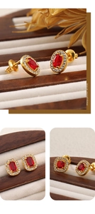 Detailed close-up of vintage 18K gold-plated stud earrings with red rubies and pavé crystals