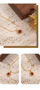 Close-up of three vintage 18K gold-plated necklaces with red zircon heart and sun pendants