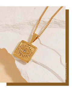 Detail view of a 18K gold PVD coated square evil eye pendant with a cubic zirconia stone