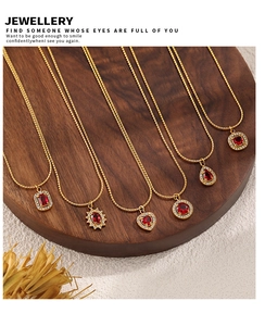 Detailed close-up of 18K gold-plated necklaces with heart and geometric zircon pendants