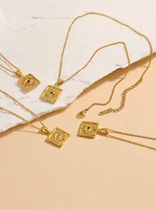 Detail of four 18K gold PVD coated square evil eye pendants with multi-color stones