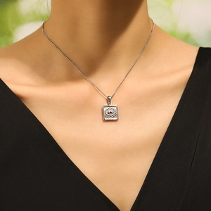 Fashionable stainless steel gold square pendant necklace with evil eye design on female model
