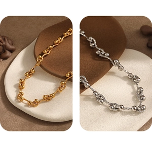 Detailed view of dual-tone gold and silver twisted chain necklaces with metal beads