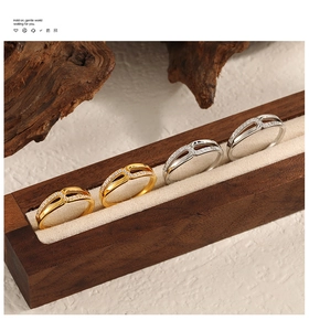 Detail von ineinandergreifenden X-Ringen mit Mikro-Diamanten in Gold und Silber