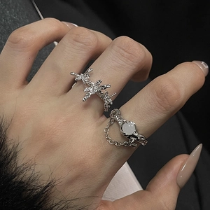 Moonstone and silver star ring set with liquid metal texture and fine chain detail