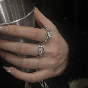 Two-piece moonstone ring set with irregular lava design and silver chain detail on hand