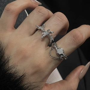 Detailed view of silver moonstone ring set with irregular textures and chain accents