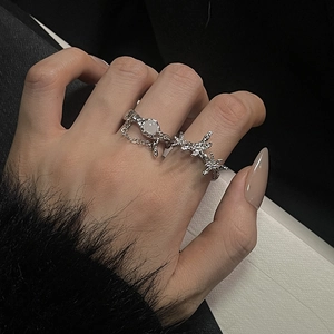 Detail shot of moonstone ring set with silver chain and star-shaped accents