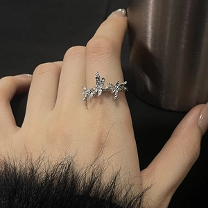 Close-up of irregular silver moonstone ring with sparkling zircons on a model's finger
