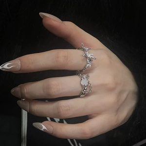 Detail of moonstone ring set with irregular lava texture and starburst diamond accents