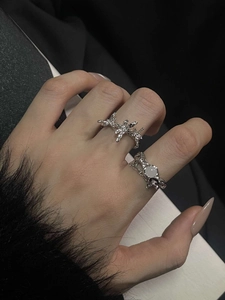 Detailed view of silver lava moonstone rings on model fingers with refined metal textures