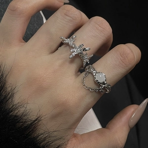 Detailed macro of silver-tone moonstone ring set with lava texture and star patterns
