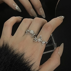 Close-up of moonstone rings featuring lava texture, thorns design and chain detail