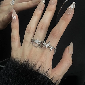 Detail of silver moonstone rings set featuring thorn star design and hanging chain